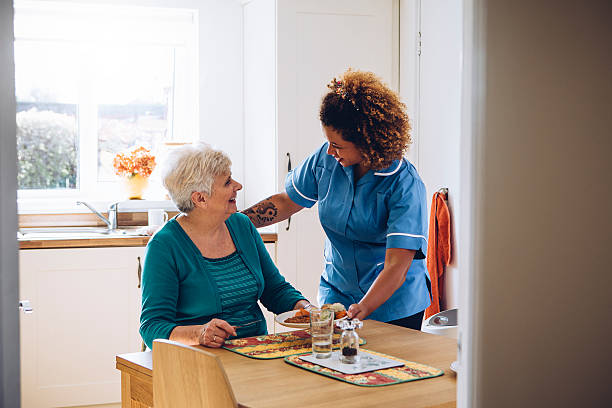 A caregiver assisting a senior at home