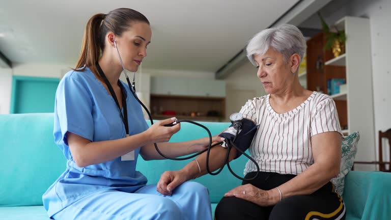 A nurse checking a patient's vitals at home