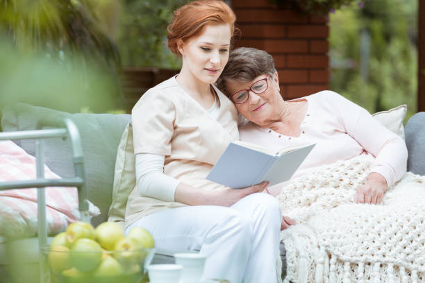 A hospice caregiver spending time with a patient